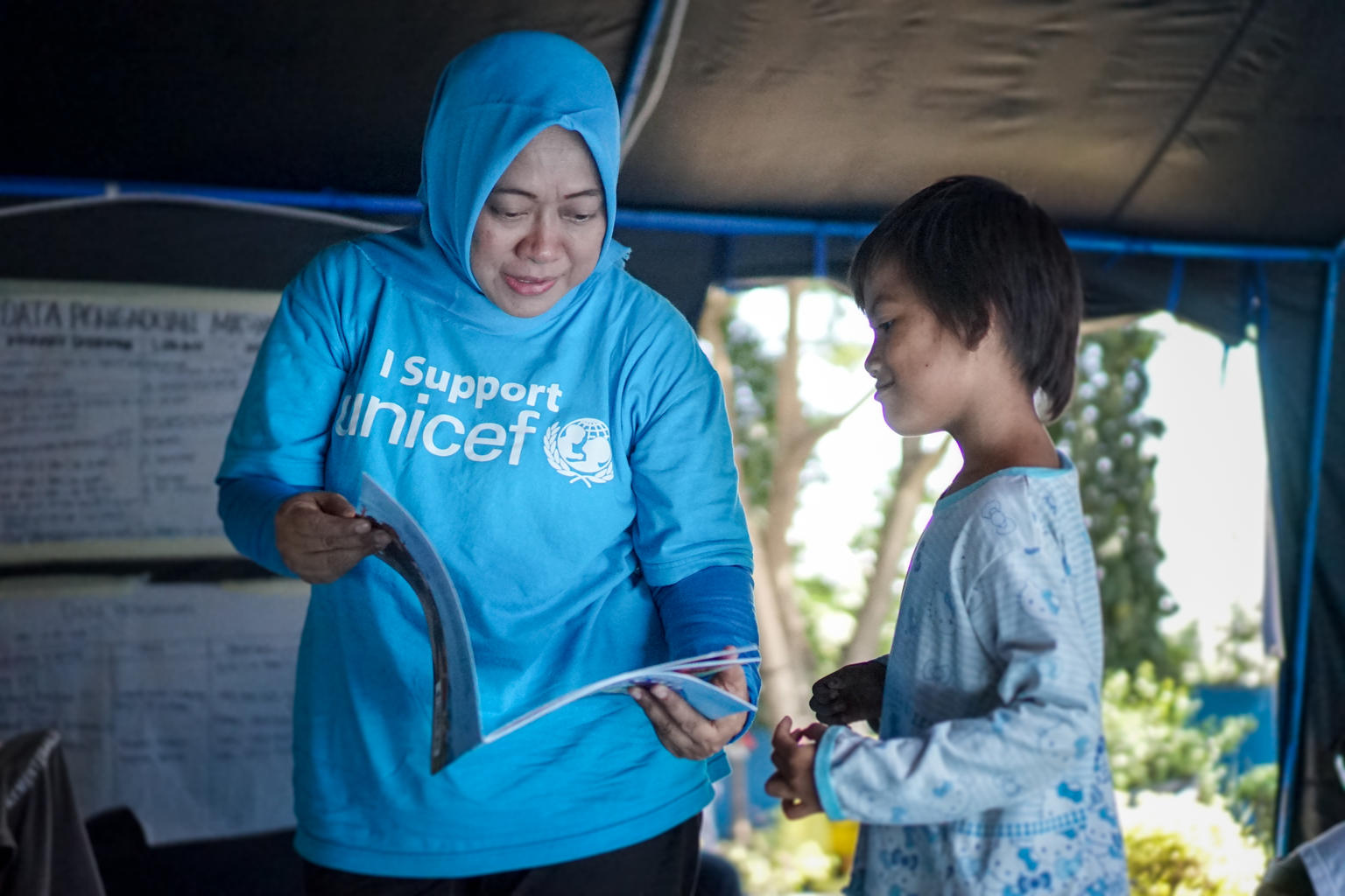 UNICEF staff providing education to child